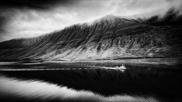 Silver & Basalt: Fishing Boat Below the Icelandic Fjords